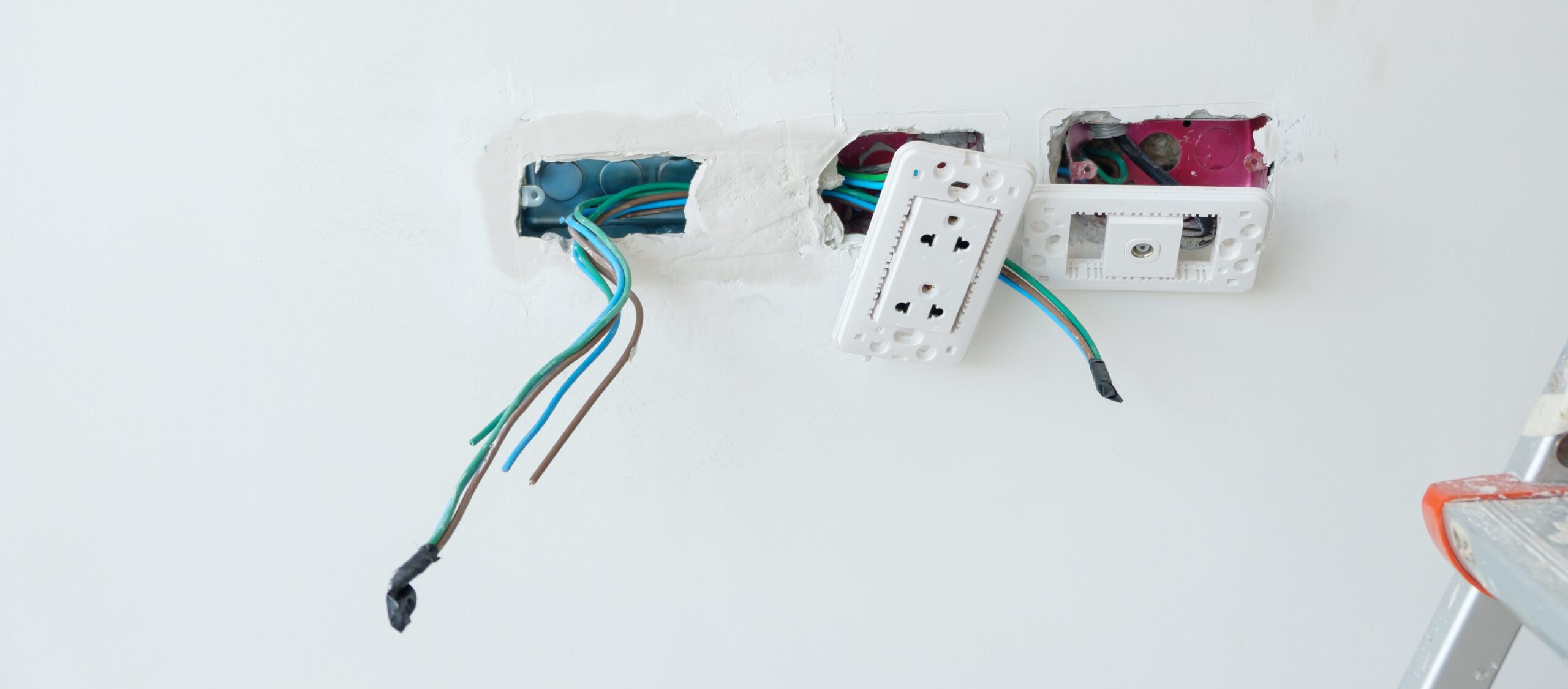 Electrician inspecting hidden electrical issues that may increase energy usage over time in a residential electrical system