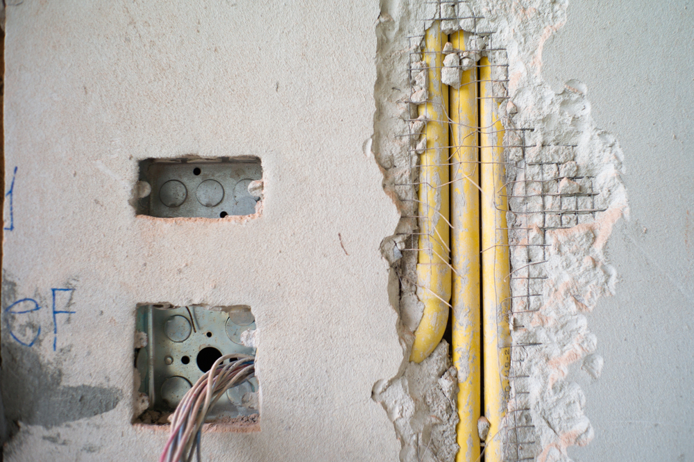Licensed electrician inspecting electrical surge damage in Salem after a July thunderstorm