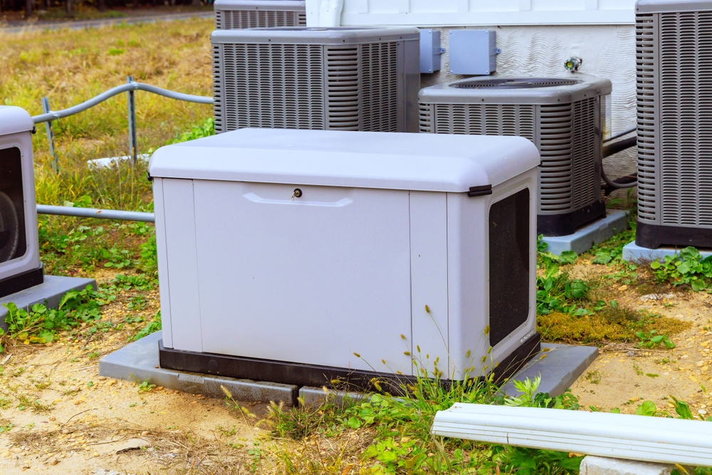 Licensed electrician inspecting a whole-house backup generator installation in Cave Spring